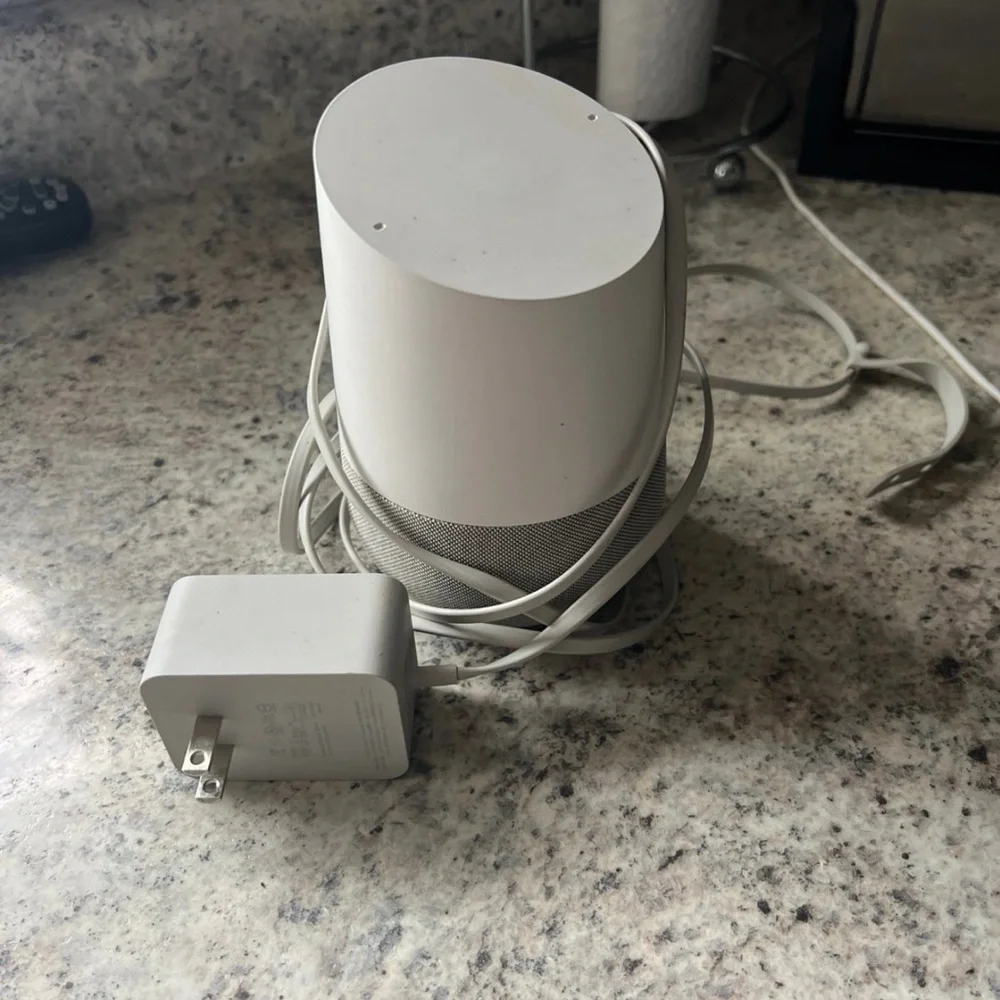 White Google home smart speaker with Charger